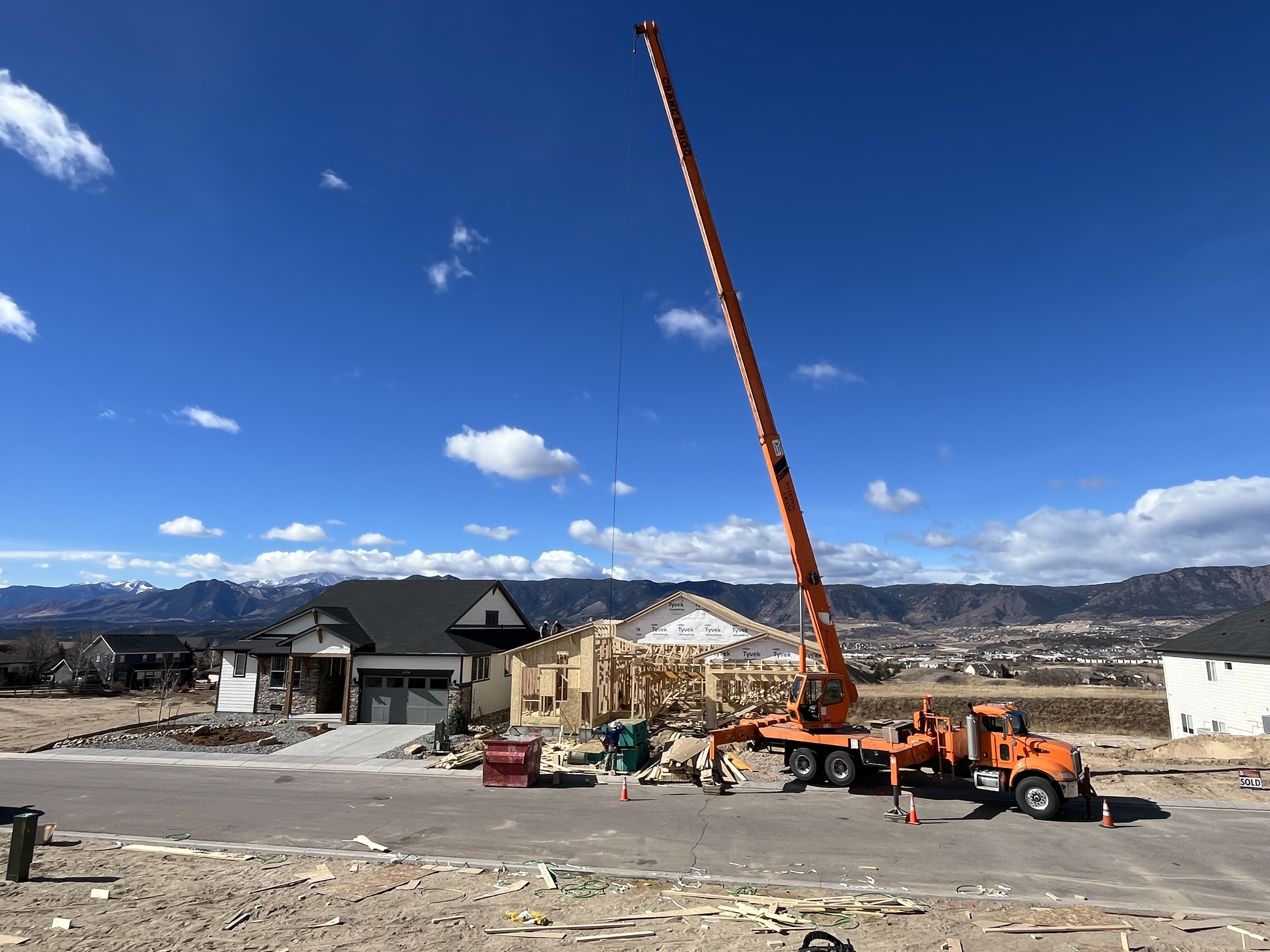 Crane setting trusses on a Front Range new home construction project