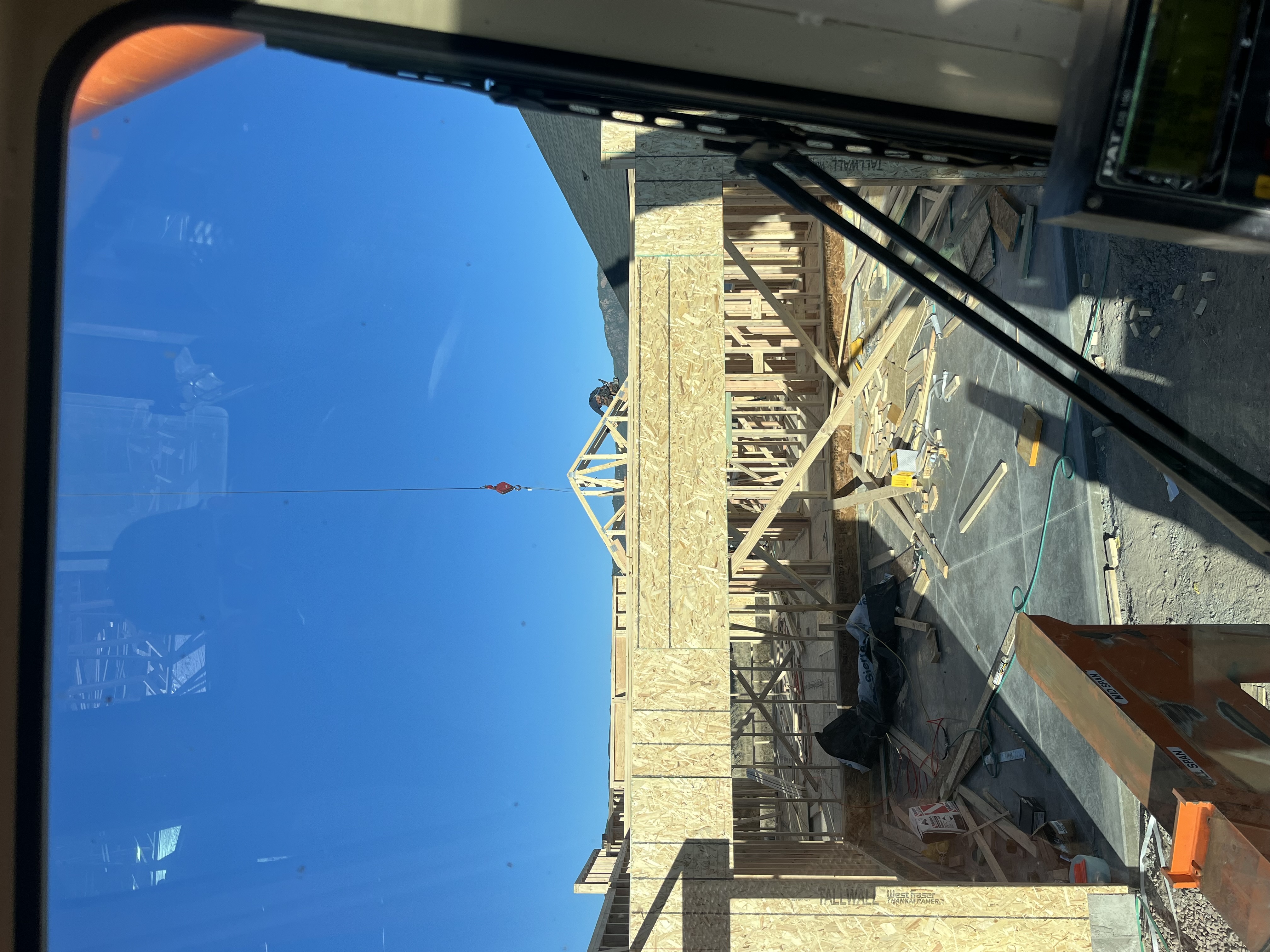 New home framing and sheathing in progress viewed from crane cab